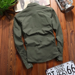 Detail view of the back yoke and reinforced stitching on a military green cargo shirt