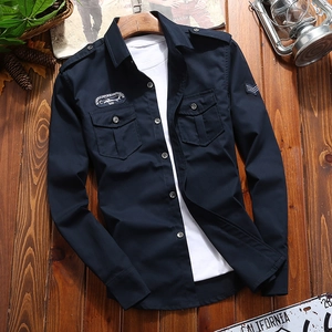Detailed view of navy blue long sleeve shirt with military style epaulettes and chest pockets