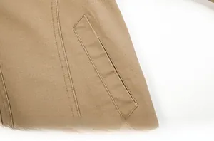 Detailed close-up of heavy-duty cotton twill fabric and reinforced pocket stitching on khaki jacket