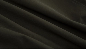Close-up of high-density deep olive cotton twill fabric showing detailed textile texture
