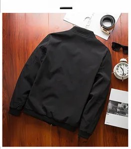 Close-up of black bomber jacket featuring ribbed collar and zipper pocket on the sleeve