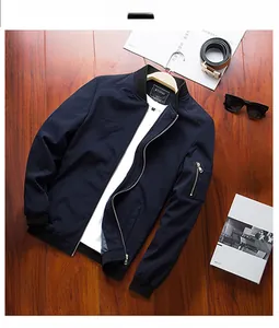 Navy blue men's jacket with baseball collar and zipper pocket on rustic wood background