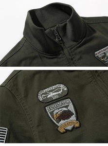 Close-up of military green tactical jacket with detailed aviation embroidery and stand collar