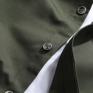 Detailed macro view of olive green shirt fabric with premium four-hole metal buttons
