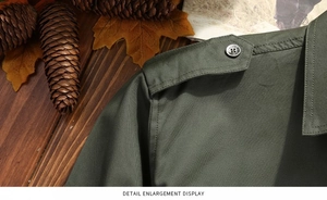 Detail shot of military green cotton shirt featuring tactical epaulettes and metal buttons