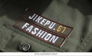 Close-up of embroidered patches and button on a military green cotton cargo shirt