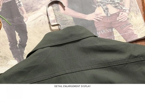 Detailed close-up of army green cotton work shirt collar and back yoke stitching