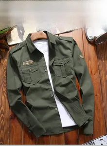 Detail of military green cotton cargo shirt with shoulder straps and embroidered patches