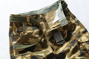 Detailed close-up of camouflage cotton cargo shorts with belt and large utility pocket