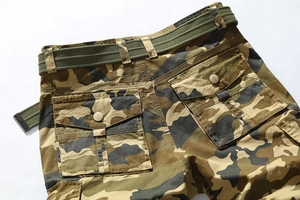 Detail of camouflage cargo shorts with buttoned back pockets and a military green woven belt