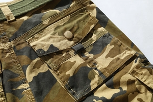 Detail of camouflage cargo shorts with flap pocket, metal button and woven belt
