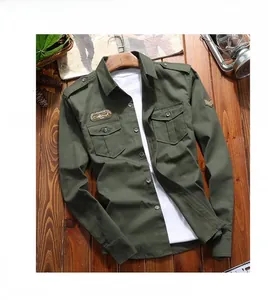 Detail of military style army green work shirt featuring dual chest pockets and shoulder epaulets