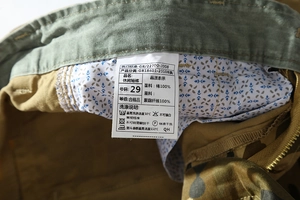 Detail of cotton camouflage shorts showing inner floral lining and 100% cotton wash tag