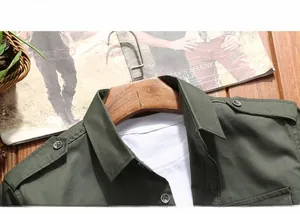 Detail of olive green military style cotton shirt with shoulder epaulettes and button