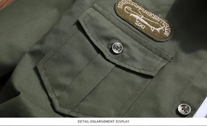 Detail of military green shirt featuring an embroidered vintage tactical patch and pocket