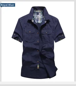 Detail of royal blue short sleeve work shirt with plaid inner collar and chest pockets
