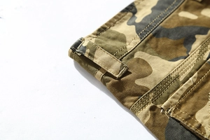 Close-up of camo cargo shorts featuring reinforced belt loops and durable stitching