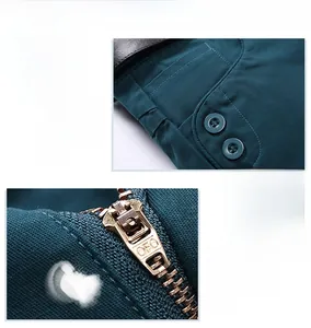 Detailed view of dark green summer shorts fabric with buttoned pockets and metal zipper