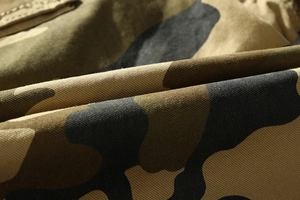 Close-up of durable camouflage cotton fabric texture on men's tactical cargo shorts