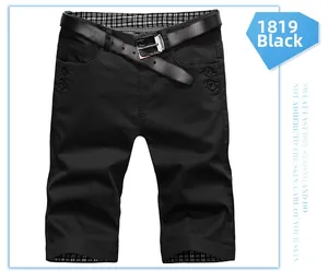 Detail of black cotton shorts featuring a woven belt and checkered pattern inner lining