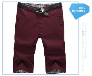 Detail of burgundy casual shorts with black belt and black-white checkered lining texture