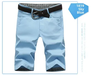 Detail of sky blue shorts featuring a brown belt and plaid inner lining patterns