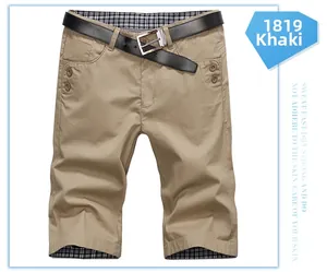 Detail view of khaki slim fit shorts with black leather belt and plaid lining accents