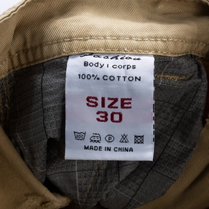 Detalle del forro de la cintura de pantalones cortos cargo con etiqueta de 100% algodón