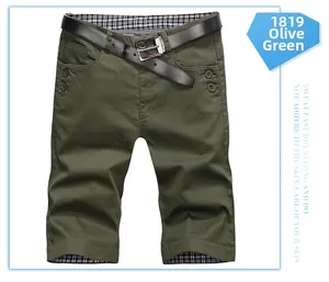 Detailed close-up of army green cargo shorts with checkered lining and a black belt