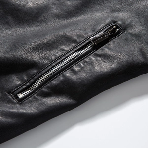 Close-up of silver metal zipper and textured matte black faux leather jacket detail