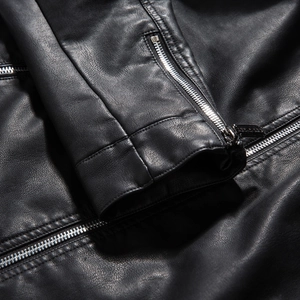 Detail of black PU leather jacket showing premium texture and silver metal zipper teeth