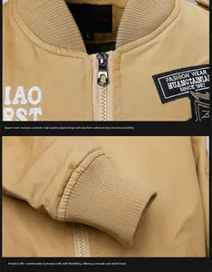 Detail of khaki cotton jacket showing front zipper, embroidery patch and ribbed cuff texture