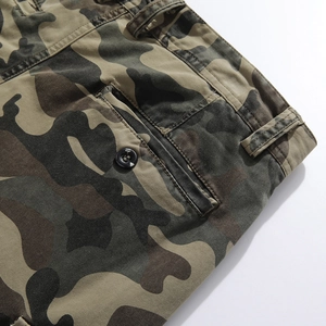 Close-up of military camouflage cargo pants showing twill fabric and button pocket detail