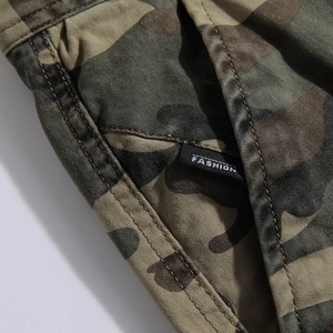 Close-up of jungle camouflage cargo pants fabric with fashion woven label and stitching