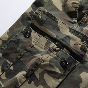 Detail of durable woodland camouflage fabric and sturdy pocket stitching on cargo pants