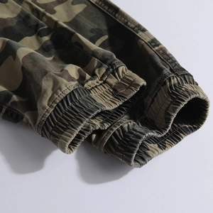 Detail shot of elastic cuffs on camouflage cargo pants with reinforced stitching