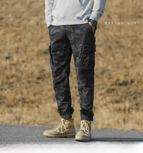 Detail view of cargo pants featuring camo patterns and large tactical side pockets