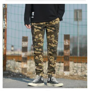 Detail view of camouflage cargo pants featuring side flap pockets and ribbed cuffs