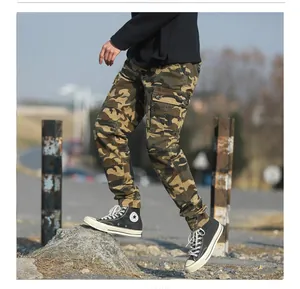 Detail of men's camouflage cargo pants featuring side flap pockets and elastic cuffs