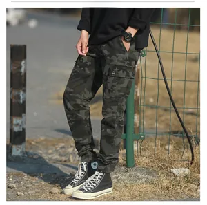 Detail of camouflage cargo pants featuring large side pockets and ribbed cuffs