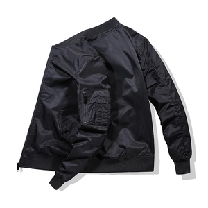 Detailed view of black bomber jacket featuring nylon fabric and ribbed collar design