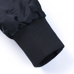 Detail shot of the black bomber jacket featuring high-quality ribbed elastic knit cuffs