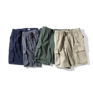 Flat lay detail of multi-pocket cargo shorts in navy, grey, army green, and khaki colors