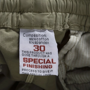 Detailed view of cargo shorts fabric label showing 95% cotton and 5% spandex blend