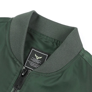 Detail of the ribbed collar and military industries label on the dark green bomber jacket