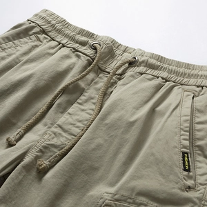 Detail of elastic waist with drawstring and metal eyelets on cargo shorts