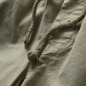 Macro shot of olive cargo shorts featuring woven drawstring and durable cotton fabric