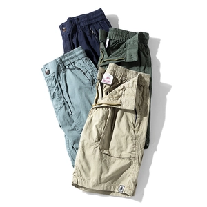 Flat lay of multi-color cotton cargo shorts showing drawstring waist and zipper pockets