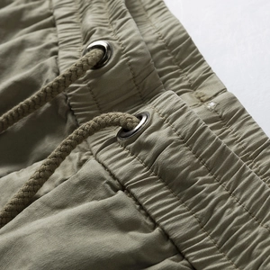 Detail of cargo shorts showing elastic waist with drawstring and metal eyelets