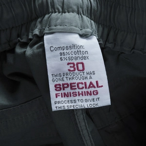 Close-up of cargo shorts label showing 95% cotton and 5% spandex material composition